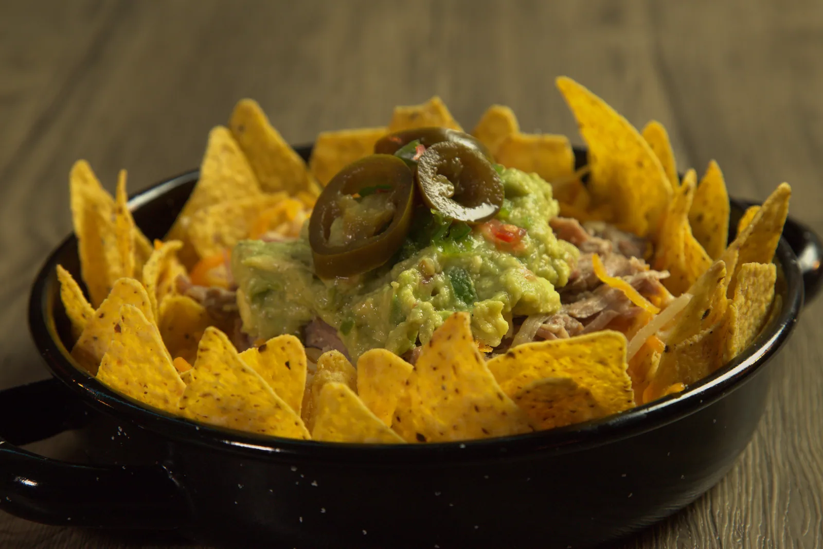 Nachos with guacamole and house pulled pork